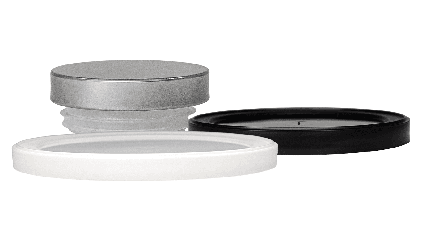 A group of container lids/snap-on lids, including a white snap-on lid, black snap-on lid and metal shelled gasket lid.